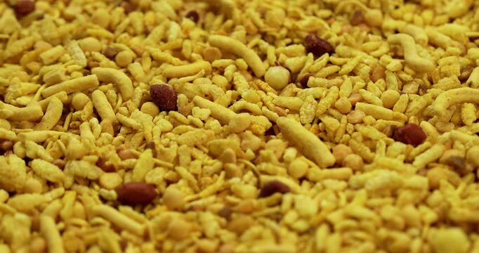 Traditional indian deep fried salty dish - chivda or farsan or namkeen made of gram flour and mixed with dry fruits, selective focus