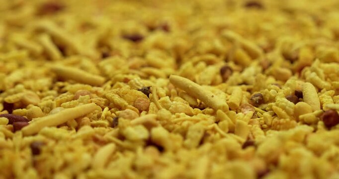 Traditional indian deep fried salty dish - chivda or farsan or namkeen made of gram flour and mixed with dry fruits, selective focus