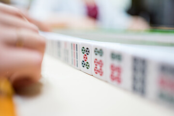 Playing a traditional game of Mahjong with friends