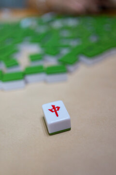 Mahjong tile game with green and white tiles