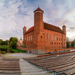 Fototapeta premium view of the Warmian Bishops Palace and the outdoor auditorium in warm evening light