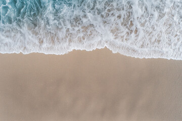 Close-Up Aerial View of Ocean Waves Reaching Sandy Beach