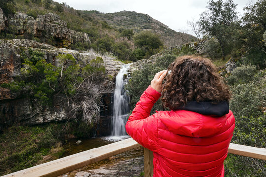Female hiker explores nature with binoculars in La Mancha