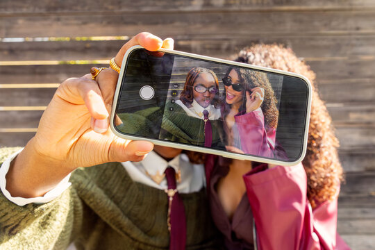 Gen Z friends taking a selfie during urban outing