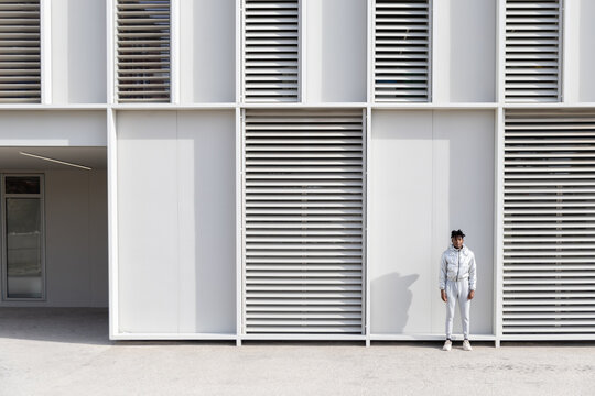 Man standing against modern futuristic building