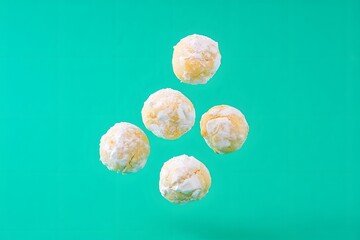 Floating Coconut Snowball Cookies on Turquoise