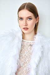 Portrait of a woman in a white transparent shirt with long blonde hair, depicted in close-up.