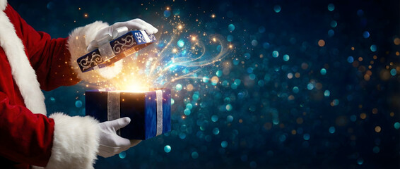 Santa's hands opening a glowing white gift box against a magical blue bokeh background..