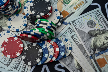 Stacks of colorful poker chips and US dollars showing casino wealth, risk, gambling and money winnings