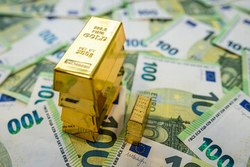 Gold and euro banknotes on table, concept of investment market, inflation hedge and economy growth