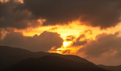 Bright sunrise over the silhouette mountains.