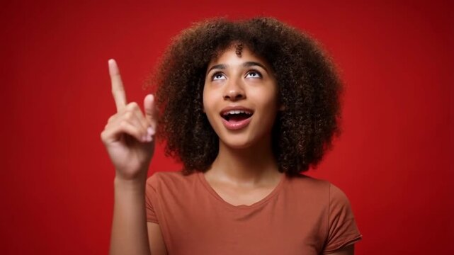 A woman pointing upwards in excitement, showcasing a eureka moment or inspiration Stock Video