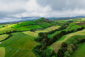 Aerial landscape with pastures and farmland on the slopes of volcanic hills, Sao Miguel Island, Azores © Leonid
