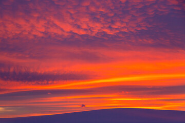 Winter landscape with mountain during amazing vivid saturated beautiful sunset sky in pink, purple, orange and blue colors. Sunset background.