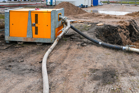 Construction site dewatering pump system removing groundwater from excavation area