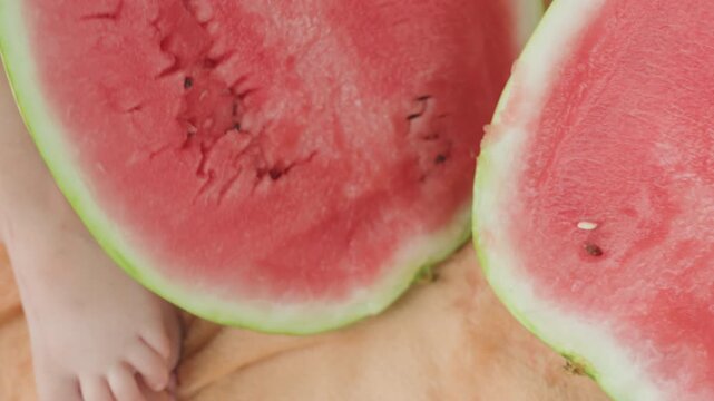 Closeup of ripening watermelon flesh, Caucasian woman assesses watermelon ripeness with manicured fingernails, Closeup of woman inspecting watermelon pulp for ripeness and juicy moisture content