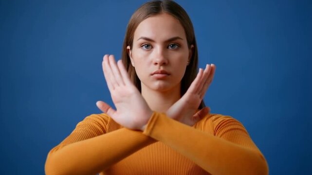 A woman with her arms crossed, making a stop gesture, indicating refusal or disagreement Stock Video