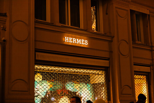 Vienna, Austria - 15 December, 2025: Hermes store sign illuminated at night in Vienna, Austria. The architecture features classic European design with ornate details.