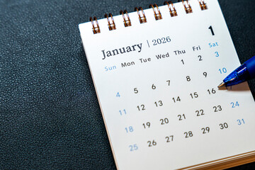 A detailed image of a calendar page for January 2026, showcasing dates and days of the week, with a pen hovering over January 16, symbolizing planning and organization.