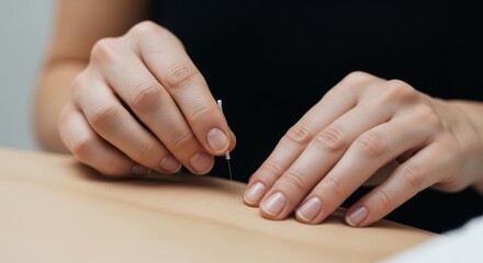 Acupuncture therapy: close-up of hands performing traditional healing technique