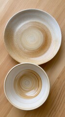 Modern ceramic plate and bowl, handcrafted appearance, beautiful spiral design, sitting on wooden background