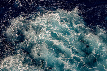 Above view of blue water churning creating white water caused by a ship engine