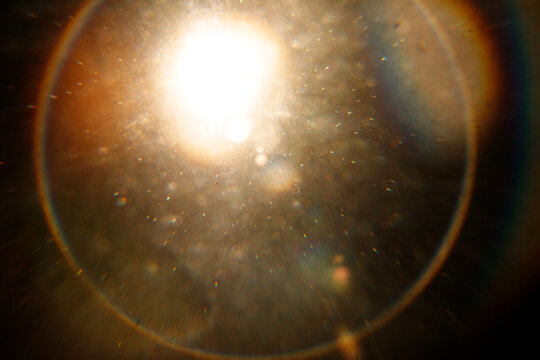 Lens Flare. Light over black background. Easy to add overlay or screen filter over photos. Abstract sun burst with digital lens flare background. Gleams rounded and hexagonal shapes, rainbow halo. big