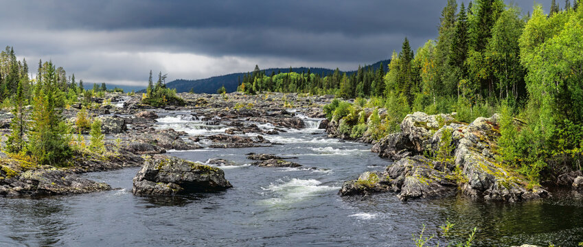 Rushing river flowing through Swedish Lapland rocky landscape
