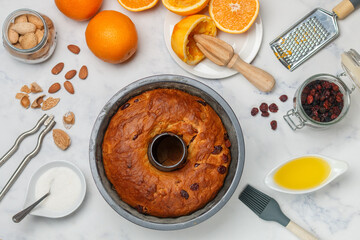 Freshly baked Kuglof, kougelhopf, Alsatian brioche with raisins, candied fruits, orange peel and almonds. Christmas mood. Easter.  Selective focus, top view