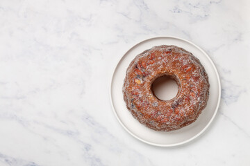 Freshly baked Kuglof, kougelhopf, Alsatian brioche with raisins, candied fruits, orange peel and almonds. Christmas mood. Easter. Selective focus, top view. Copy space