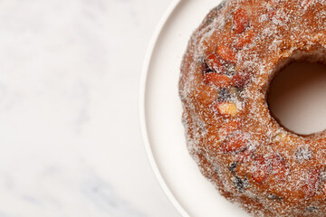 Freshly baked Kuglof, kougelhopf, Alsatian brioche with raisins, candied fruits, orange peel and almonds. Christmas mood. Easter. Selective focus, top view. Copy space