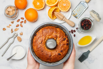 Freshly baked Kuglof, kougelhopf, Alsatian brioche with raisins, candied fruits, orange peel and almonds. Christmas mood. Easter.  Selective focus, top view