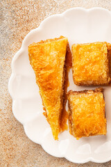 Baklava with pistachios and almonds dessert oriental sweets natural product tasty snack fresh delicious gourmet food background on the table rustic top view copy space