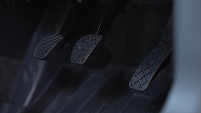 close up of car break, accelerator and clutch.
