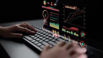 A close-up view of hands typing on a keyboard while interacting with vibrant data visualizations, illustrating modern analytics in a digital environment. Impute
