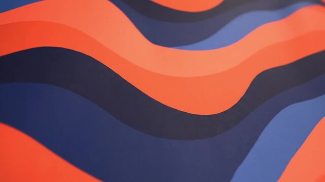 Wavy lines in orange and blue colors moving in a continuous pattern