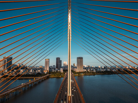 Symmetric modern cable-stayed bridge over Han River in Da Nang, Contemporary urban span connecting city skyline across Vietnamese waterway