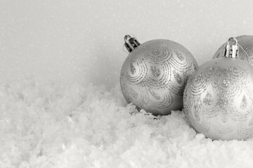 Gray Christmas balls lie on snow, front view, copy space. Demonstrating color of 2026 year, Cloud, Dancer