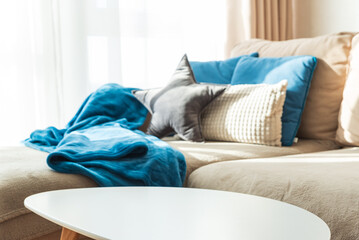 Festive Living Room with Coffee Table, Cushions, Blue Blanket, and Natural  Sun Light © thayra83