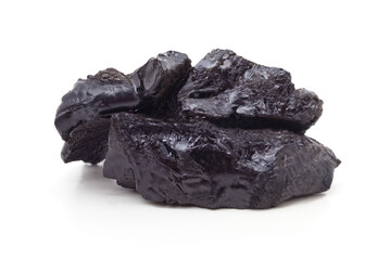 Pile of natural shiny brown-black resin isolated on a white background.