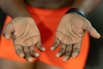 Human hands with dark skin showing open palms