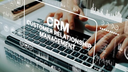 Hands Typing on Laptop Keyboard with CRM Customer Relationship Management Graphics Overlay and Data Visualization Elements. Asymptotic smart data analytic.