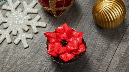 Christmas cupcake with decorative red poinsettia flower