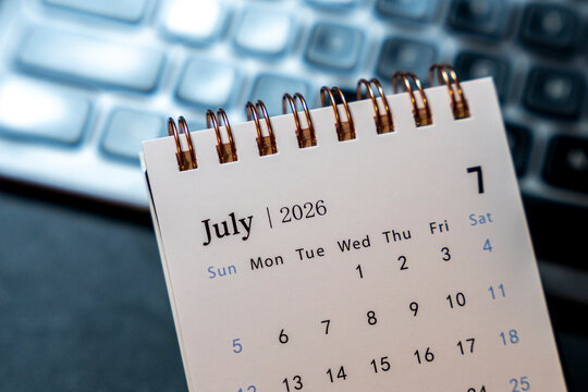 A close-up view of a desk calendar displaying July 2026, highlighting dates. Ideal for planning, scheduling, or time management discussions in an office setting.