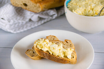 Sandwich with egg and delicious whole grain baguette with sesame seeds. Nutritious breakfast concept