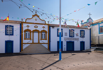 Nossa Senhora do Pilar church in Cinco Ribeiras village, Terceira Island, Azores, Portugal. Traditional Azorean architecture with blue and white facade under clear sky
