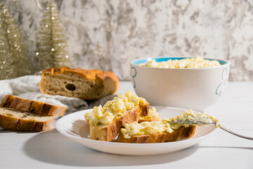 The process of preparing for the Christmas and New Year holidays. Making sandwiches with baguette, processed cheese and egg