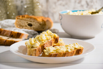 The process of preparing for the Christmas and New Year holidays. Making sandwiches with baguette, processed cheese and egg