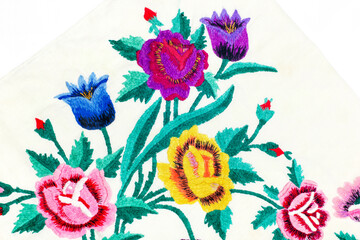 Colorful floral embroidery on cotton fabric with floral patterns on a white background.