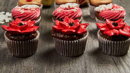 Christmas cupcakes close-up with red decoration
